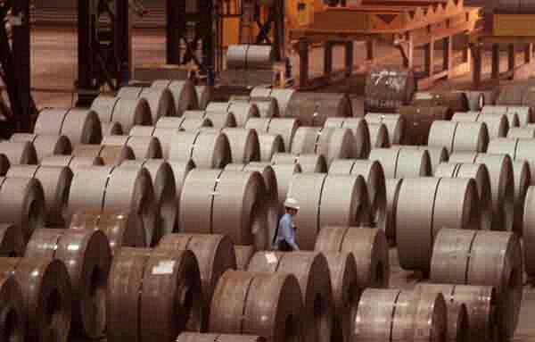 Bethlehem Steel's new coil steel mill. A worker walks through a group of coiled rolls of steel sheets.<br>Photograph by Barbara Haddock Taylor.